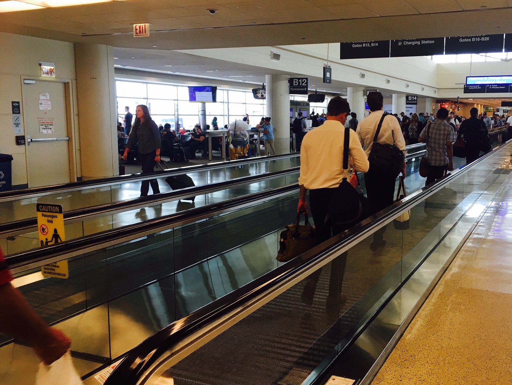 View of passengers on an airport people mover.