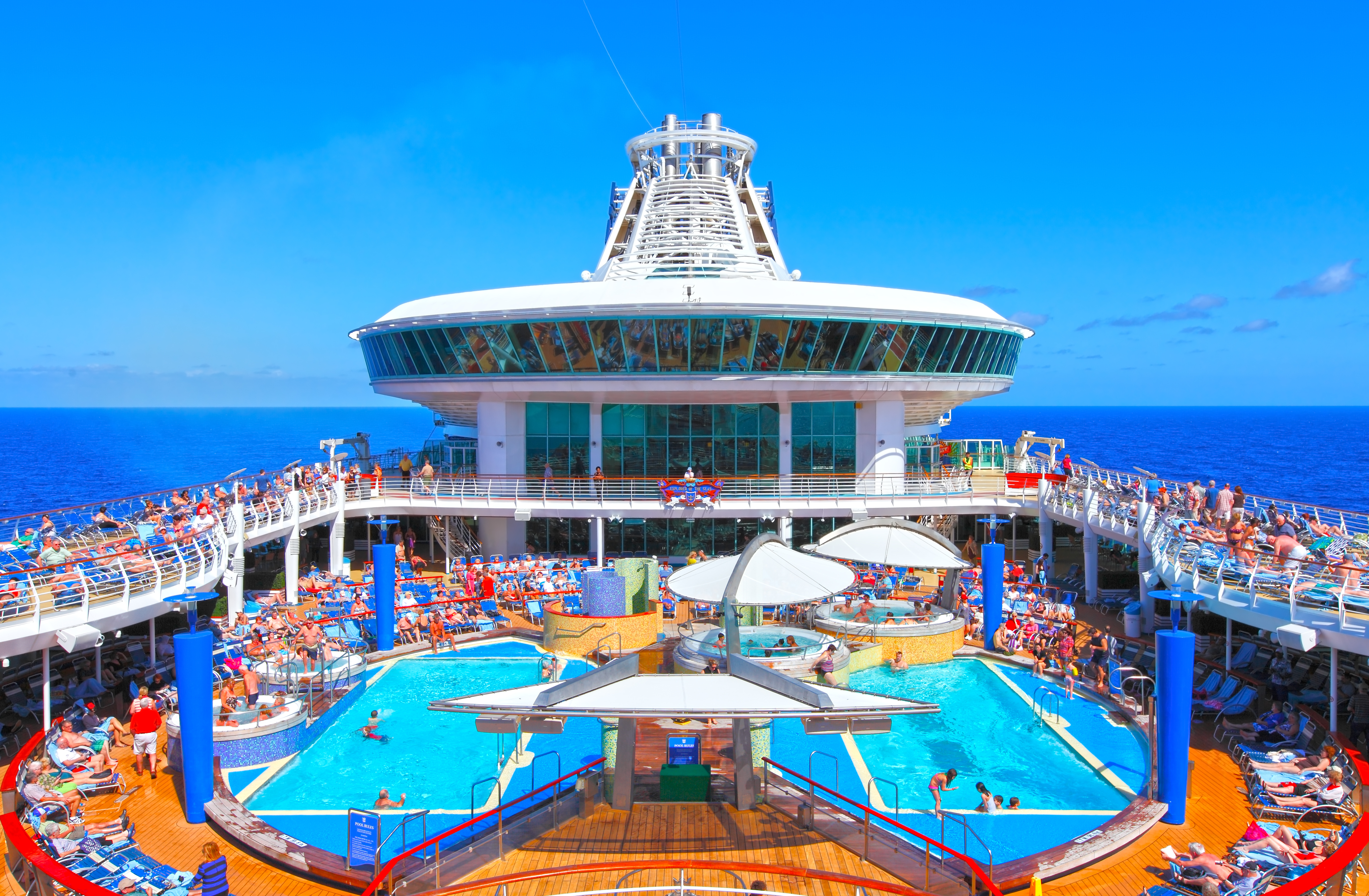 Adults and children enjoying the pool deck.