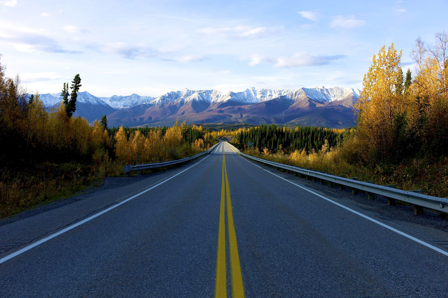 A view of an open highway with mountains in the distance.