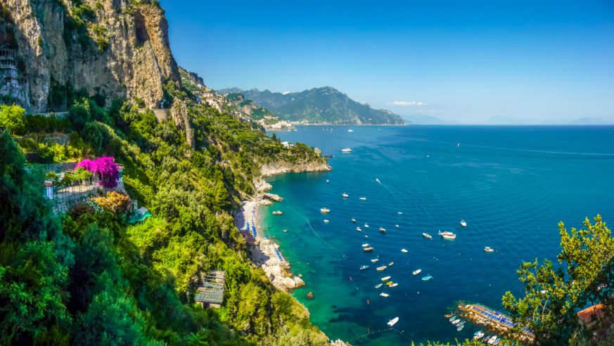 green cliff and blue water