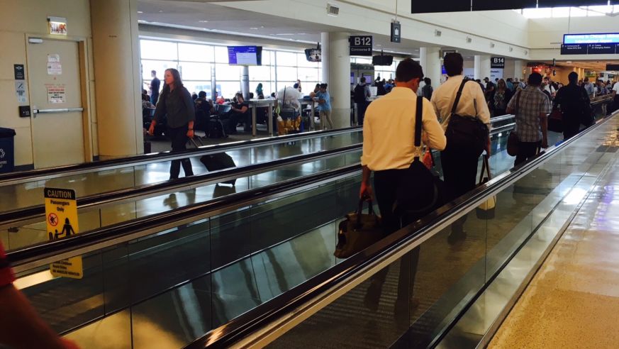 View of passengers on an airport people mover.