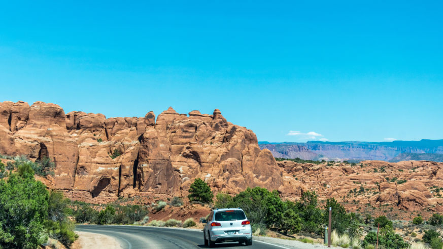silver car on road with red landscape