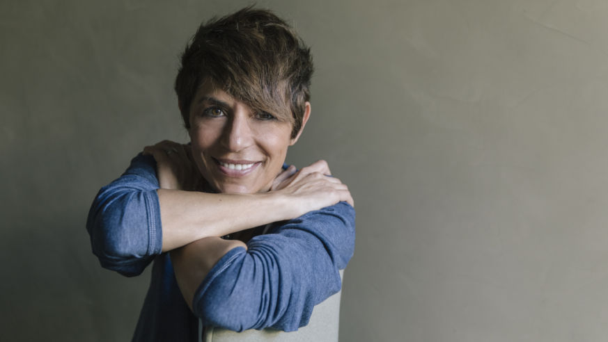 portrait of woman in blue shirt sitting
