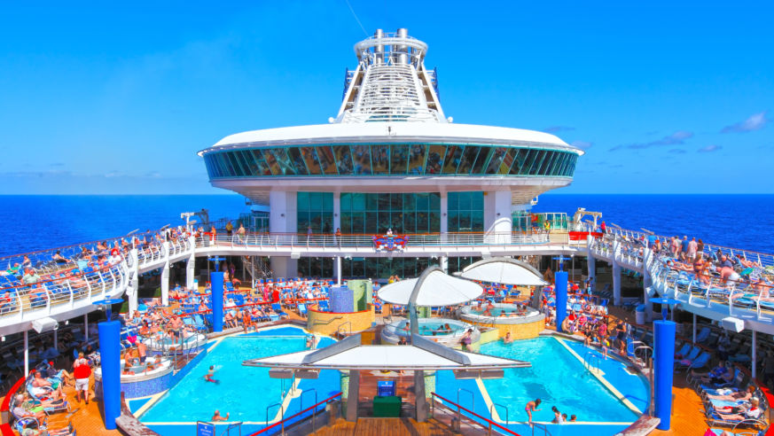 Adults and children enjoying the pool deck.
