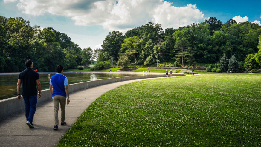 Two men walking through park
