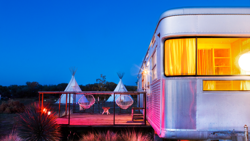 Trailer at dusk tents in background
