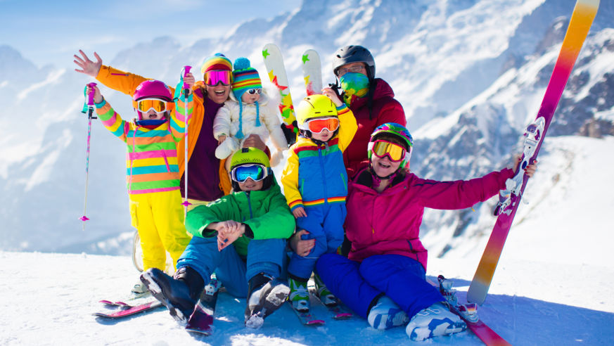 Happy Family on Mountain top skiiing