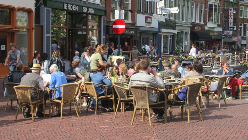A street scene with people at cafe tables in Friesland, Netherlands
