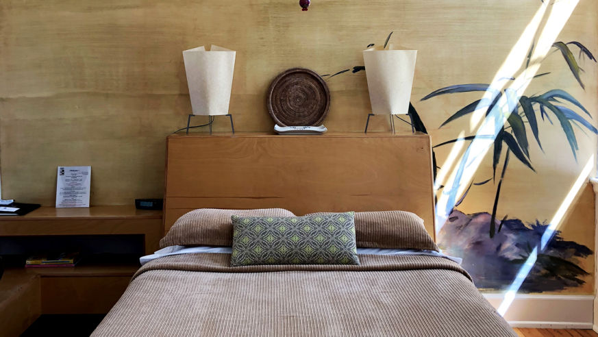 Hotel room Bed with sunlight coming in window