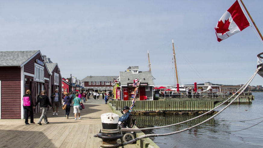 pier on a sunny day with crowds and canadian flag
