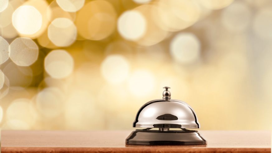 concierge bell on counter lights in background
