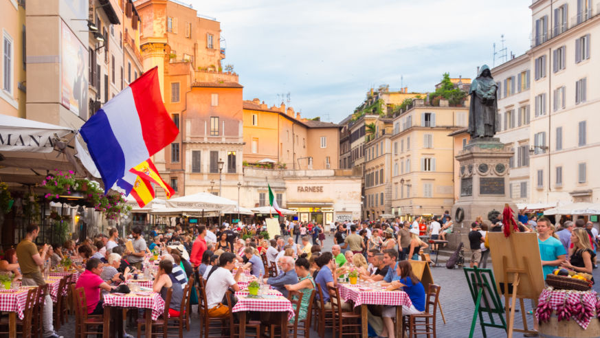 Tourists eating outside Pizza in Rome
