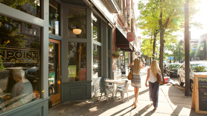 Two women walking past restaurant