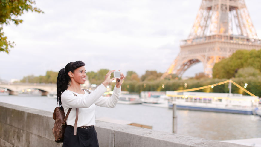 woman taking photo by river