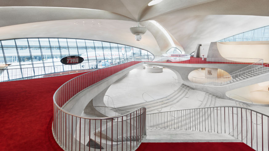 View of the white and red interior of the TWA Hotel at JFK airport
