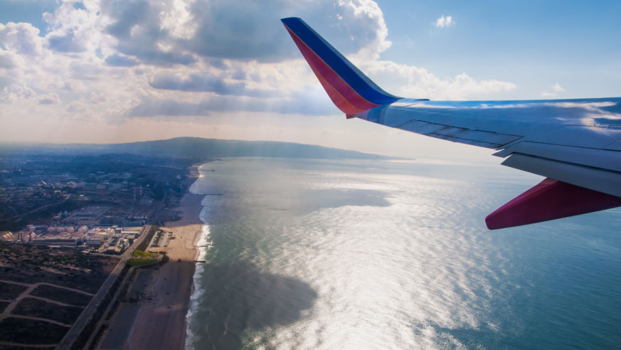 airplane tale with coastline below