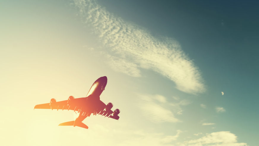 looking up at airplane taking off