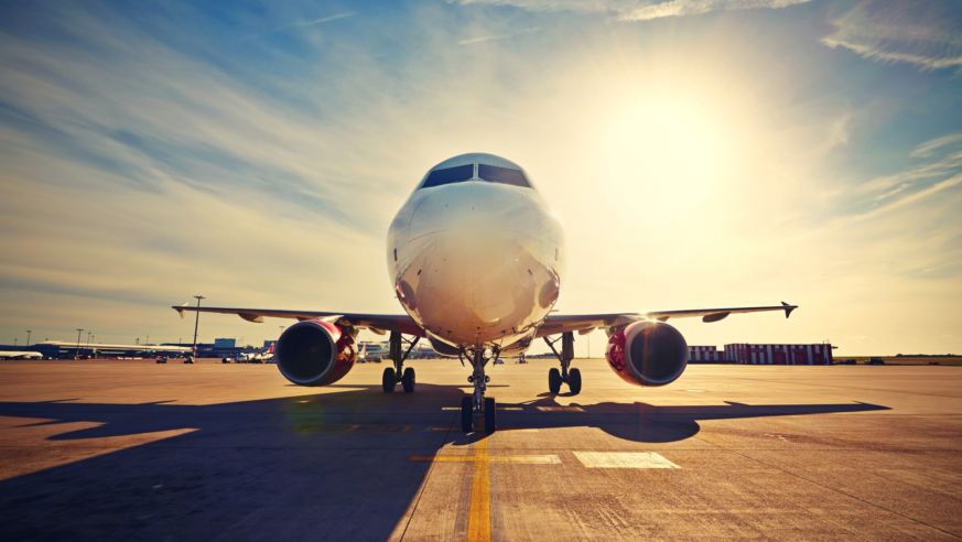 airplane on runway sunset
