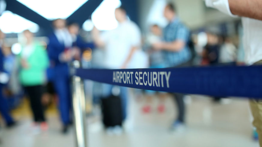 A sign reads "airport security" at an airport.