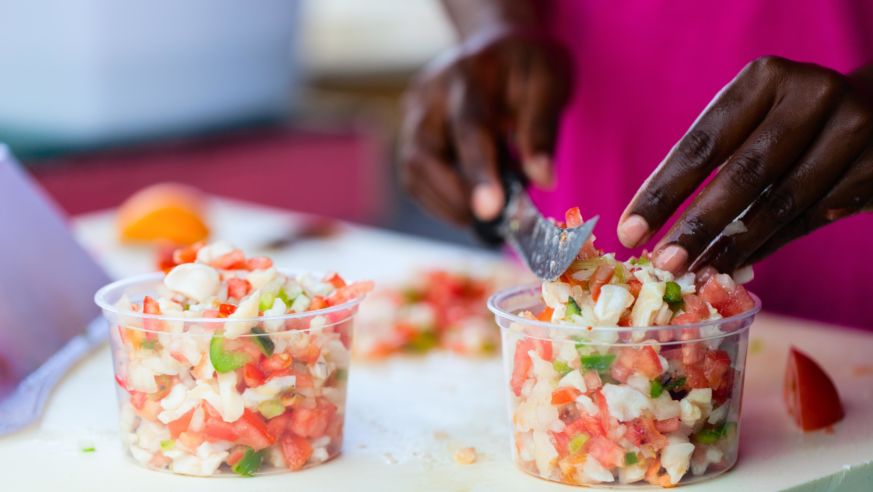 Bahamian woman making traditional conch salad