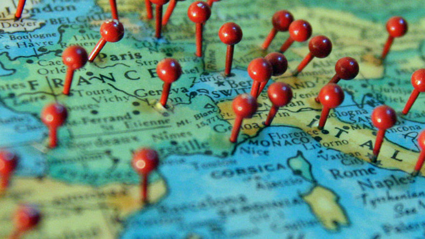 Dream trips map with push pins in it.