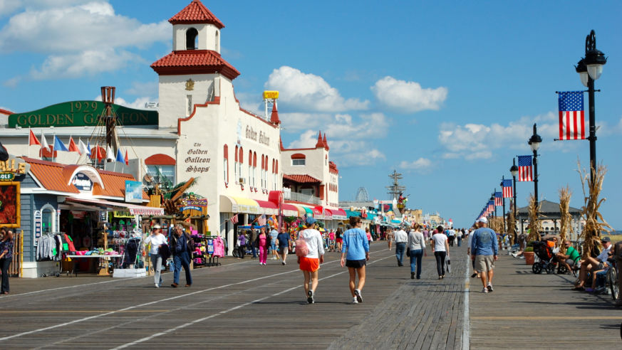 sunny day people walking on boardwalk