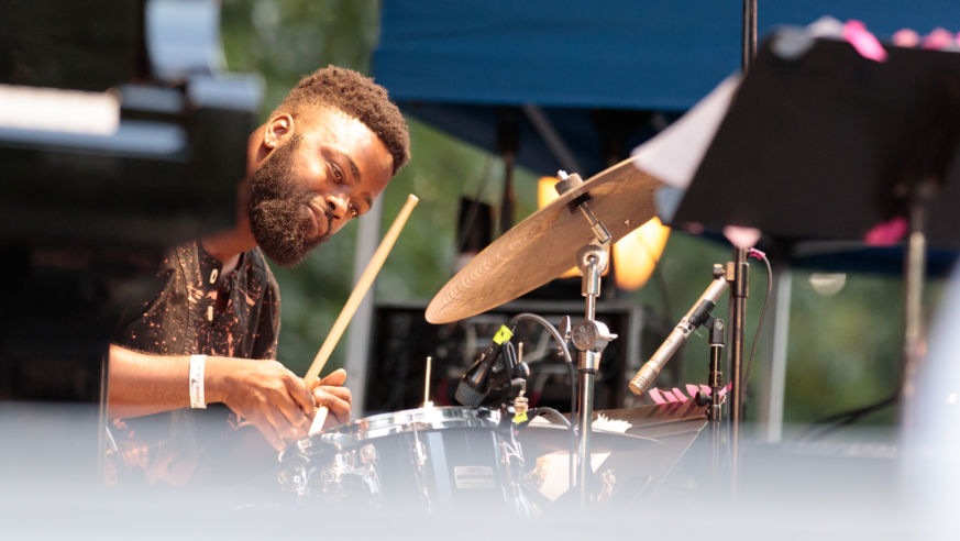 A jazz drummer play9ing at the Charlie Parker Jazz Festival in NYC