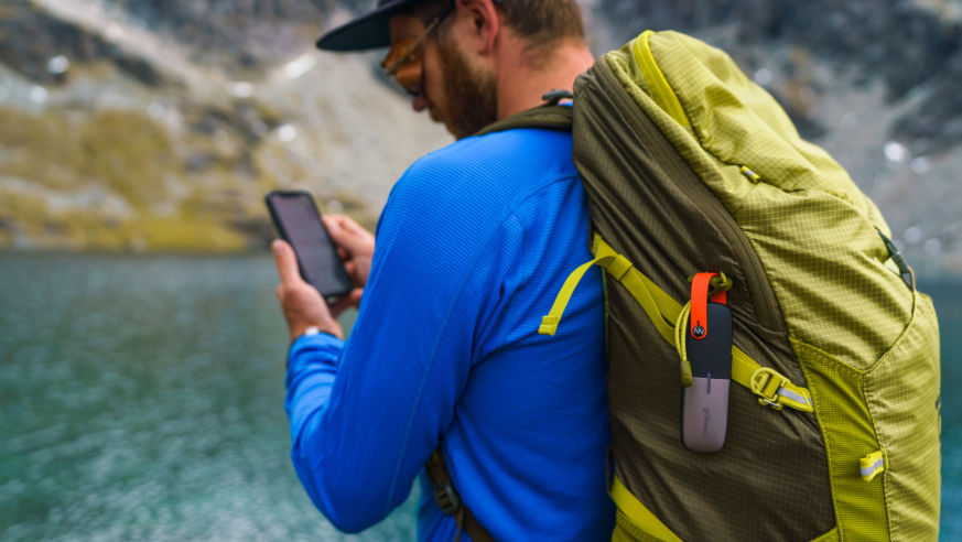 Man on phone with backpack