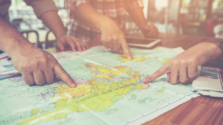 hands pointing to paper map