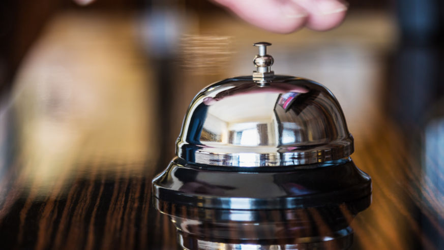 hand about to ring concierge bell