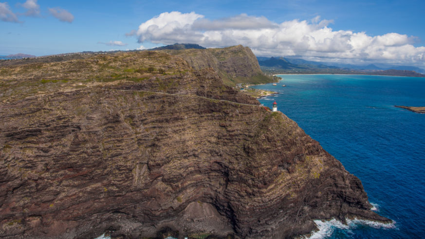 rocky cliff with lighthouse at tip