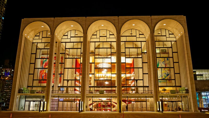 A view of the front windows and chandeliers of the Metropolitan Opera House in New York City.