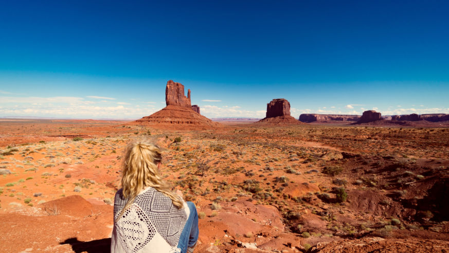 woman alone looking out at monument valley