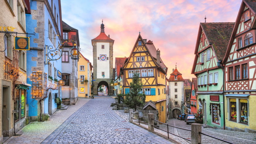 A view of the charming town square of Rothenburg, Bavaria, Germany, with clock tower and medieval buildings.