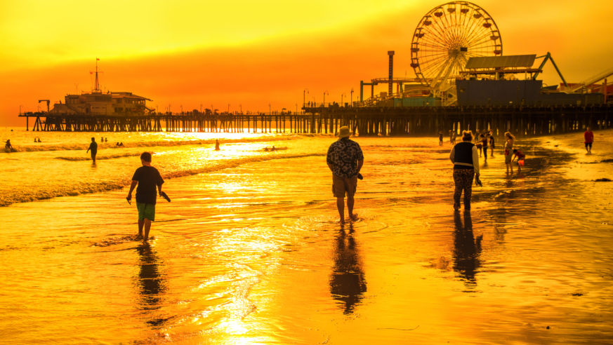 View of the sun setting behind Santa Monica beach and pier