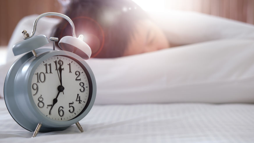 Sleeping woman near clock