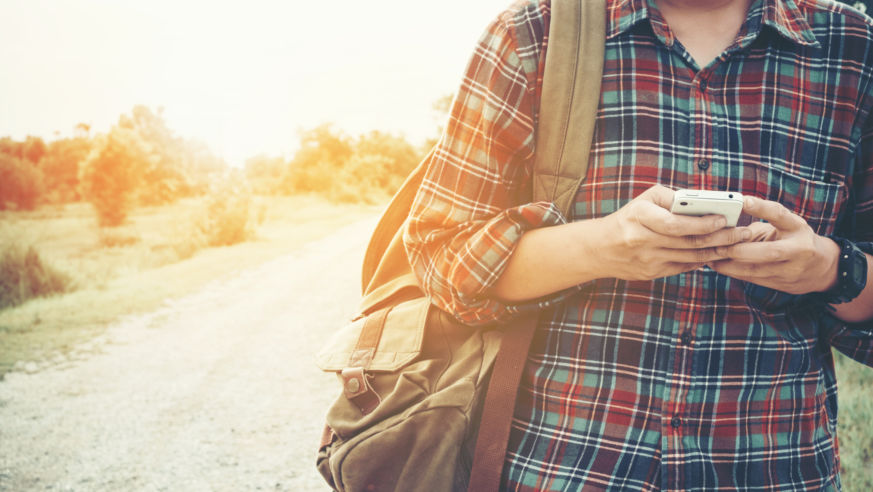 man traveling alone using phone