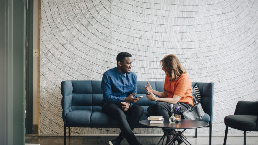 Two People Talking Using A Translator App