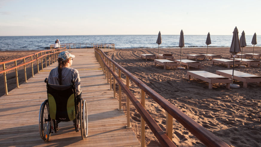 Woman in wheel chair on boardwalk