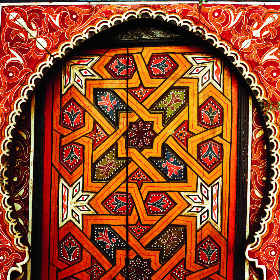 The namesake artifact at Riad Porte Royale, an elaborately carved and painted 19th-century door.