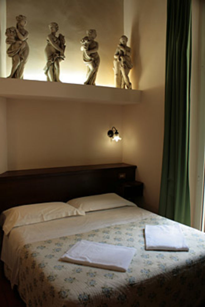 Classical statues and frescoes decorate some of Hotel Panda's rooms.