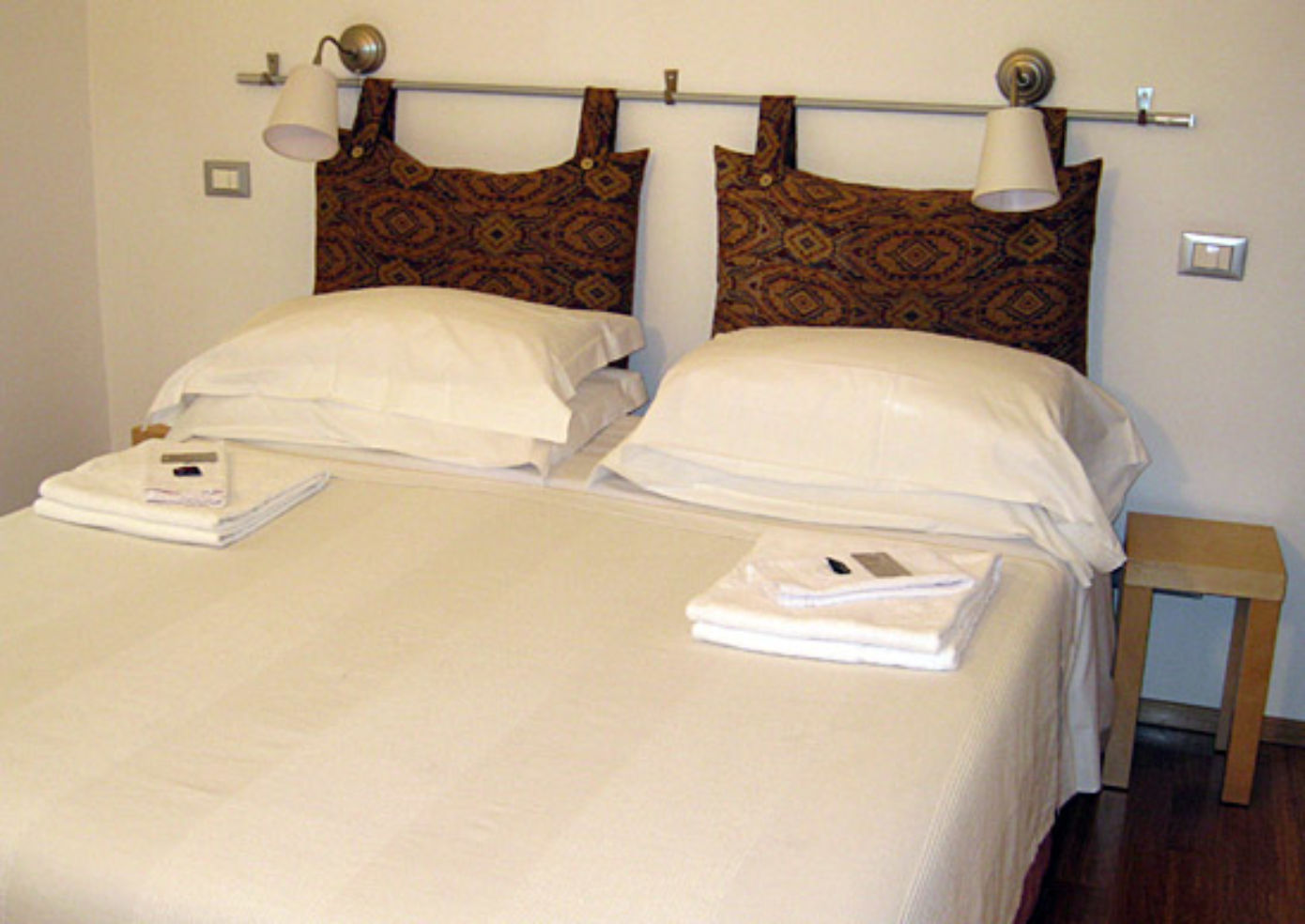 The modern, spare rooms have white linens, some punctuated by batik pillowcases.