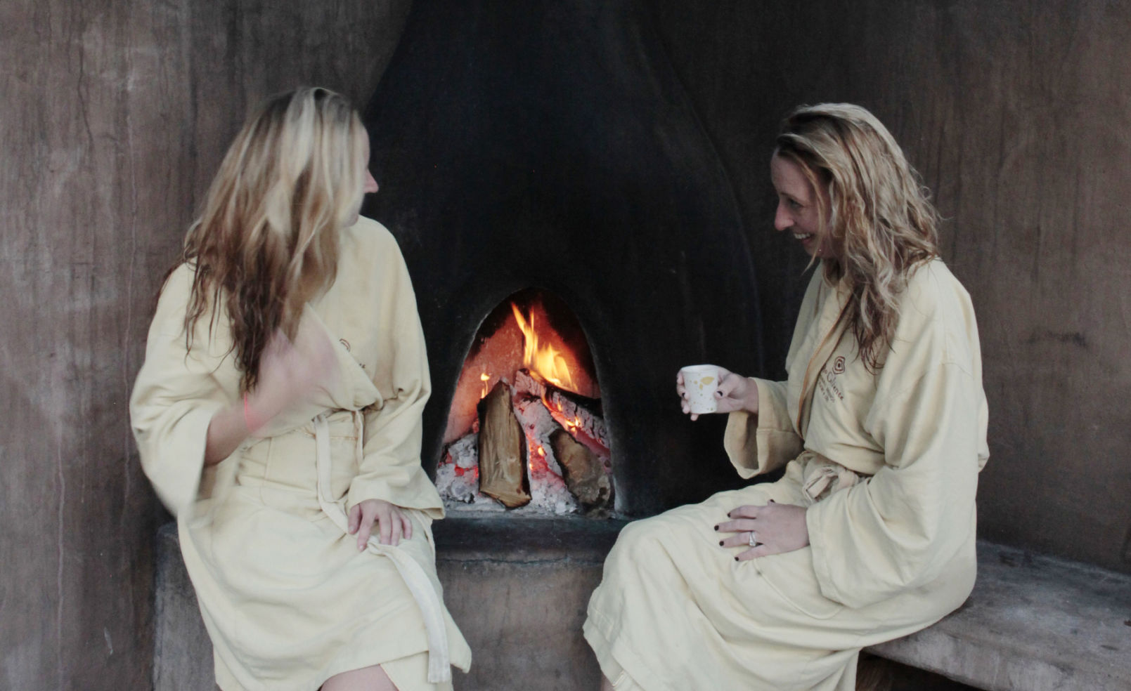 Quiet conversation post-soak next to a private fireplace at Ojo Calient