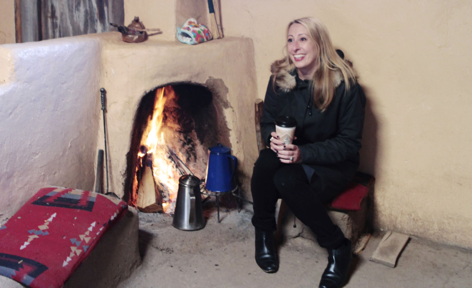 kickin’ it old-school beside a traditional fireplace at Taos Pueblo