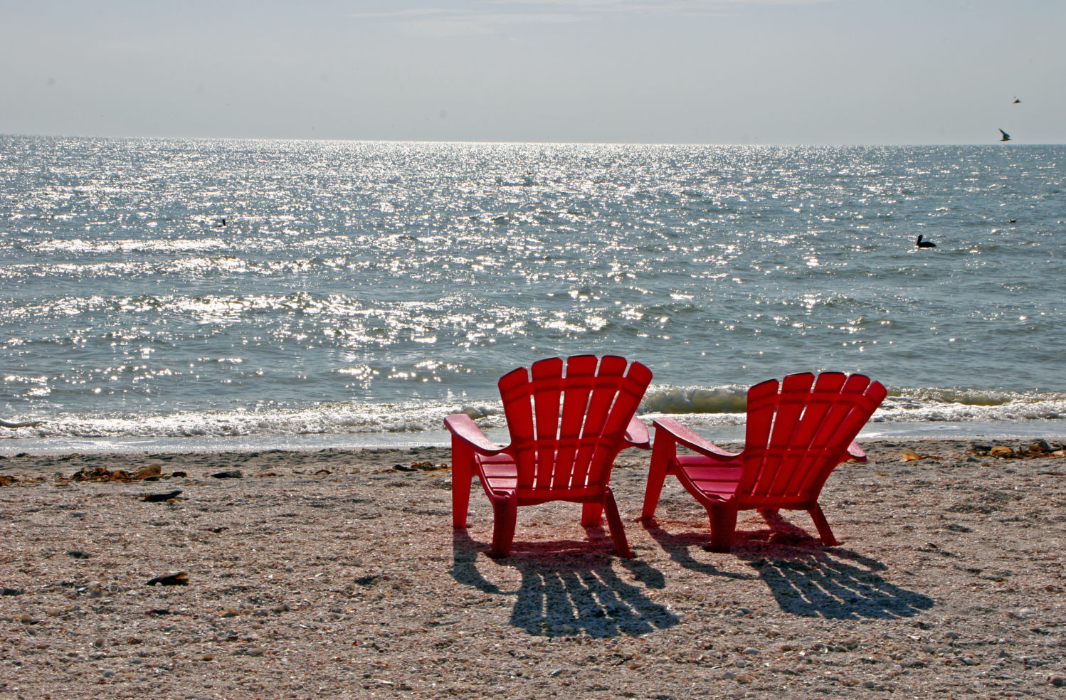 Two red beach chairs Sanibel Island Florida