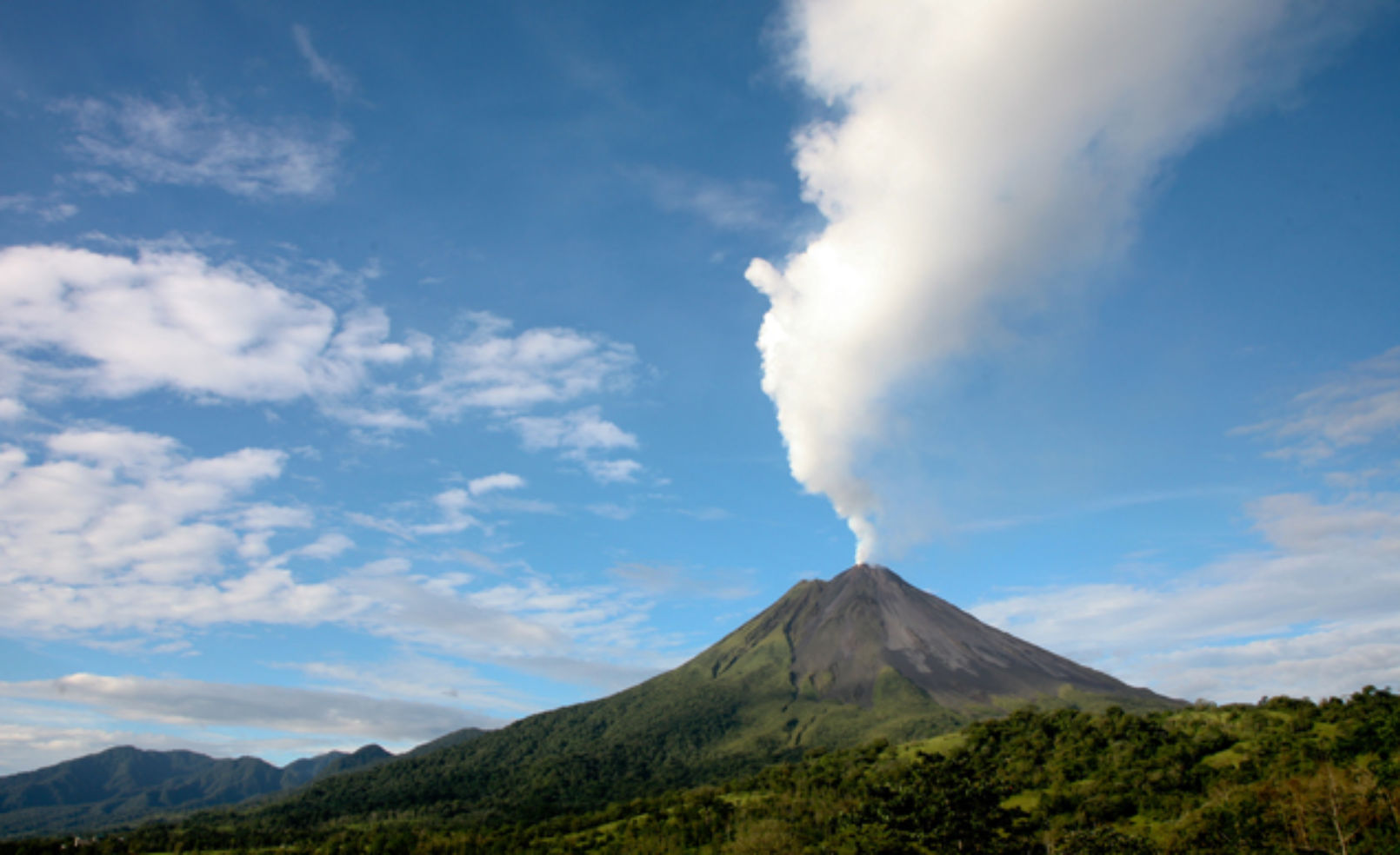 Arenal volcano in costa rica with a plume of smoke