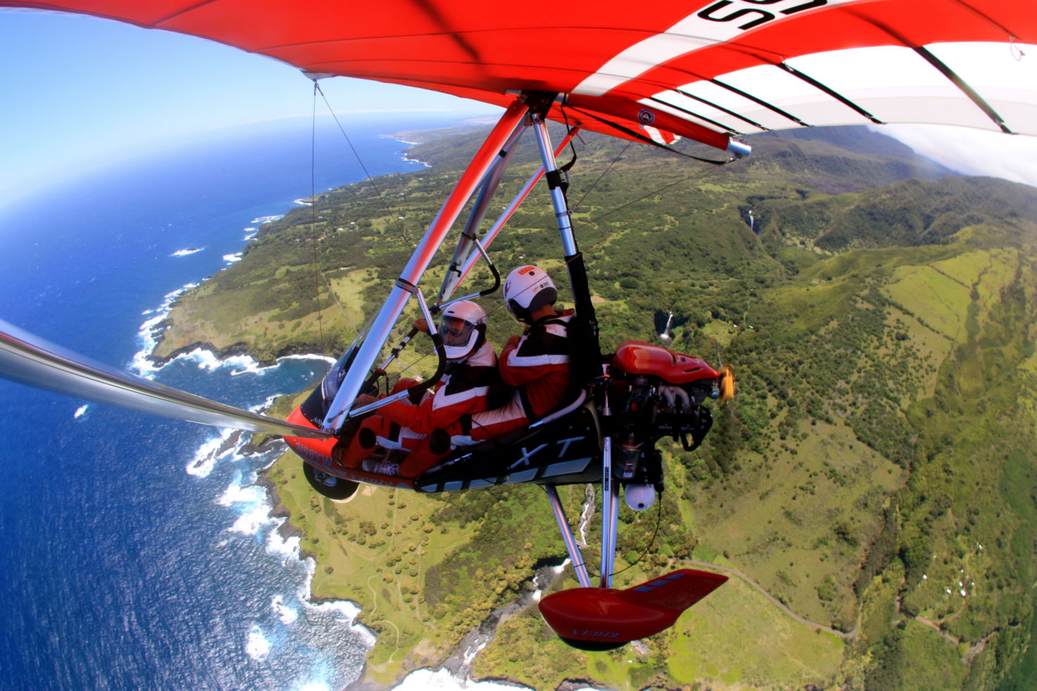 Powered hang gliding over waterfalls in Maui, Hawaii