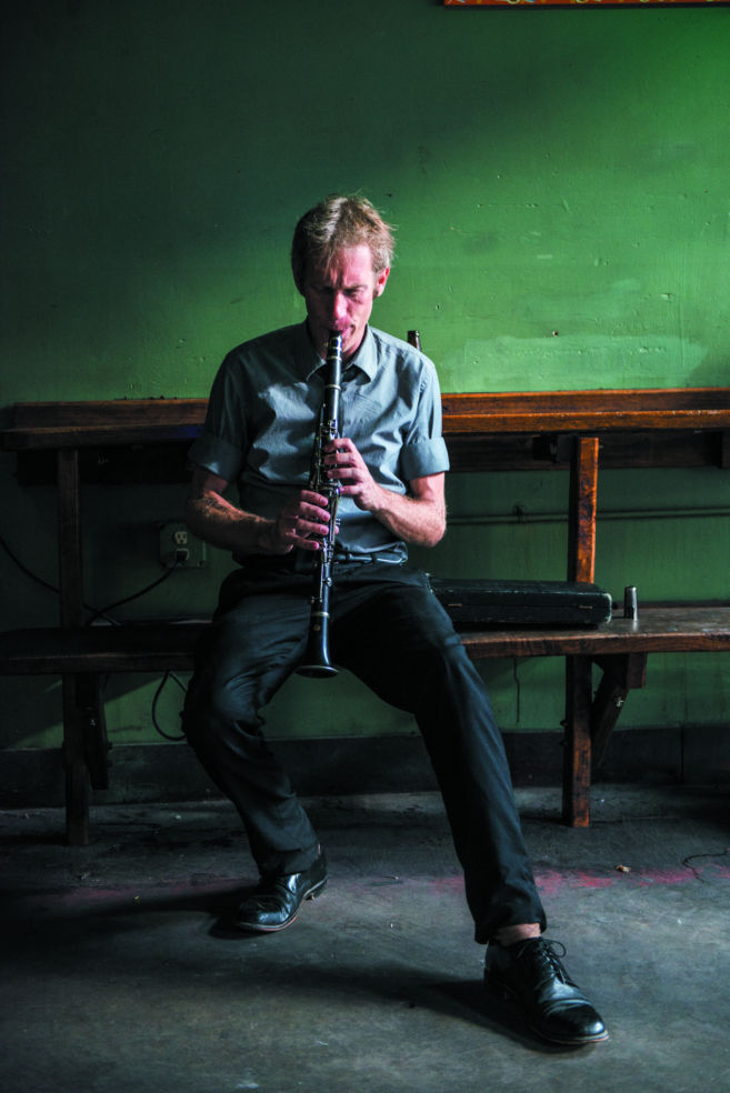 A member of the Sazerac Sunrise Band warms up on his clarinet