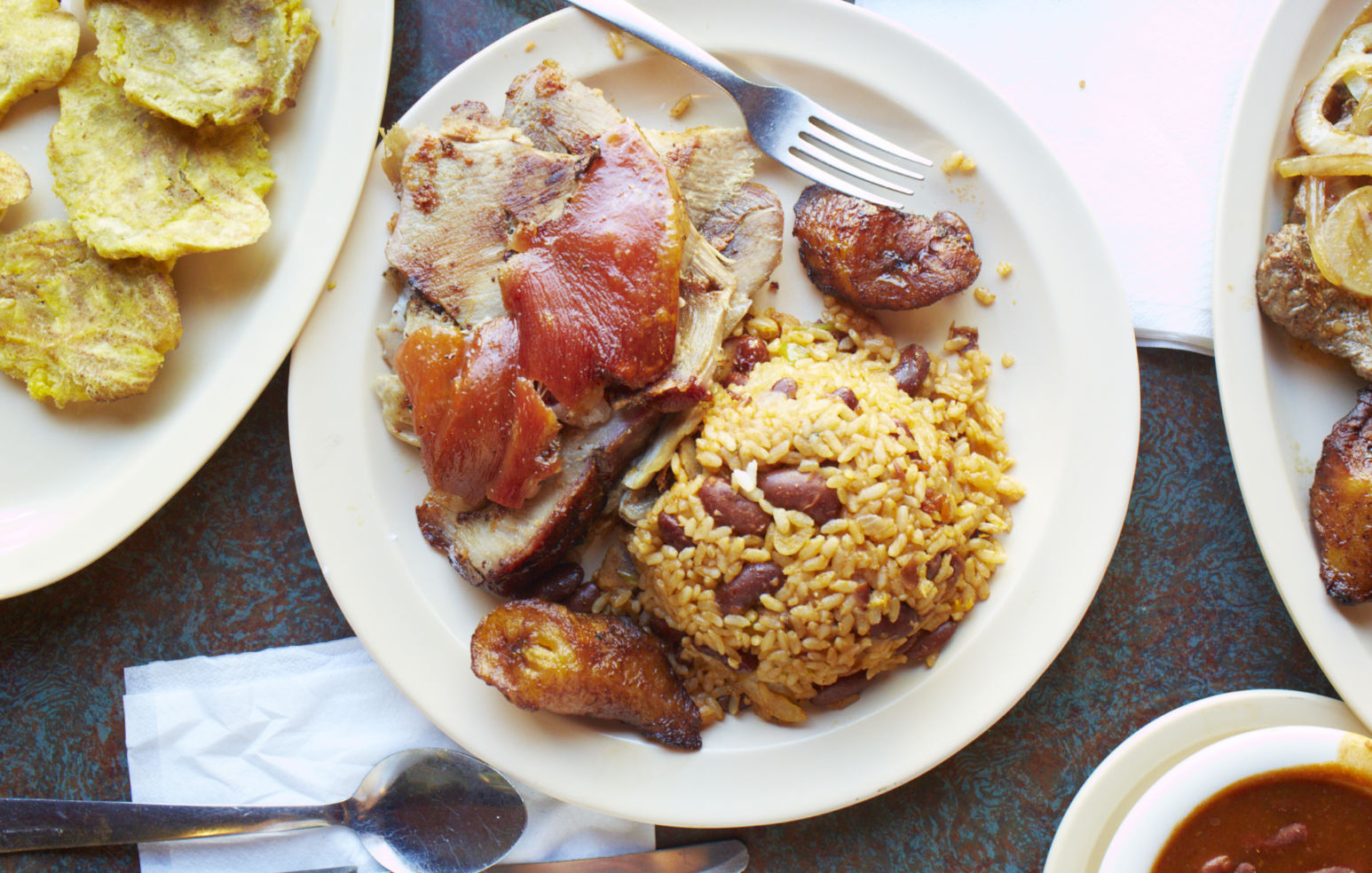 An irresistible plate of roasted pork, rice and beans, and fried plantains in San Juan, Puerto Rico.
