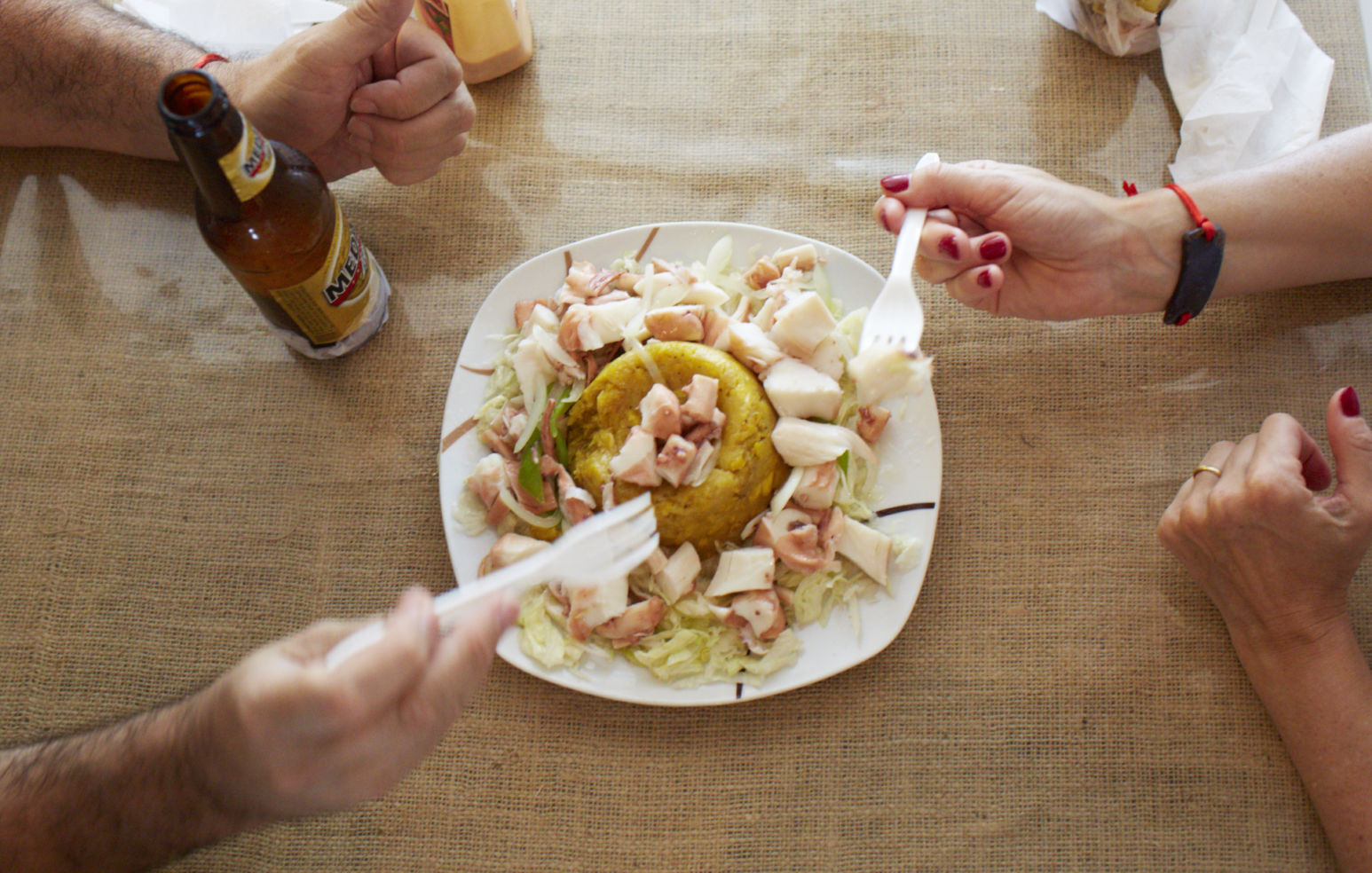 A plate of mofongo with seafood and a local beer, Medalla, in San Juan, Puerto Rico.